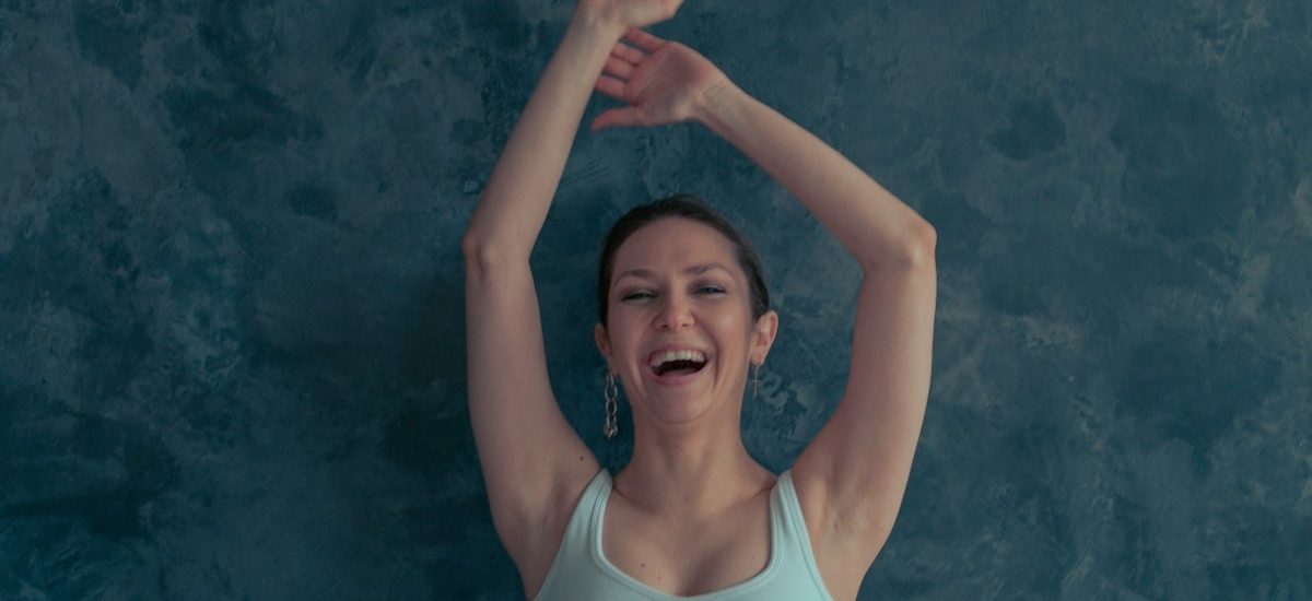 a woman with her arms up in the air