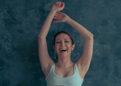 a woman with her arms up in the air